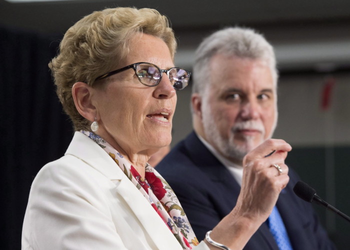 Ontario Premier Kathleen Wynne left and Quebec Premier Philippe Couillard hold a media availability after meeting in Toronto on Monday