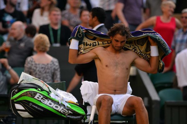 Spain's Rafael Nadal changes his shirt in the