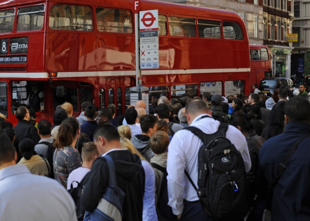 People queue for buses outside Liverpool Street Station London as commuters face travel misery trying to get to work because of a strike which has brought London Underground to a standstill. PRESS ASSOCIATION