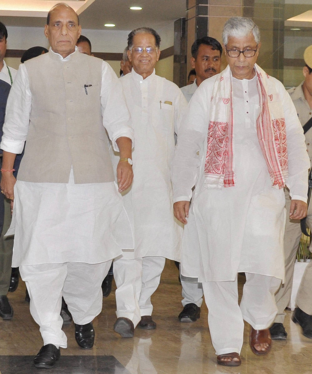 Union Home Minister Rajnath Singh along with Assam Chief Minister Tarun Gogoi and Tripura Chief Minister Manik Sarkar arrives to attend a meeting of chief ministers of the Northeast states in Guwahati on Saturday