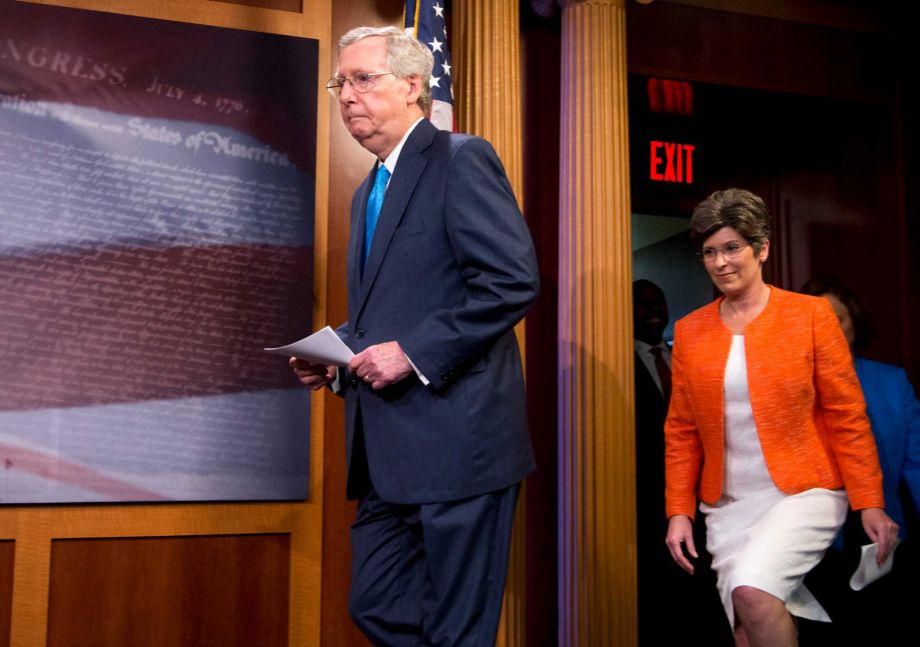 Senate Majority Leader Mitch Mc Connell of Ky. followed by Sen. Joni Ernst R-Iowa arrives for a news conference on Capitol Hill in Washington Wednesday