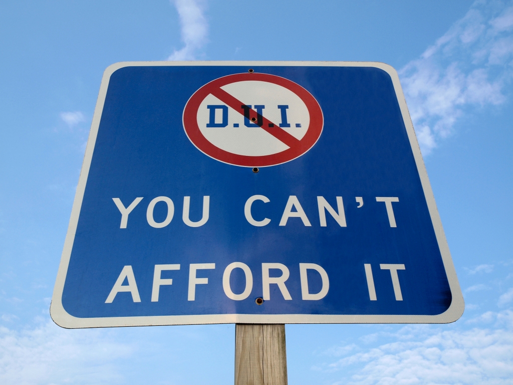 Highway sign with DUI crossed out saying'You Can't Afford It