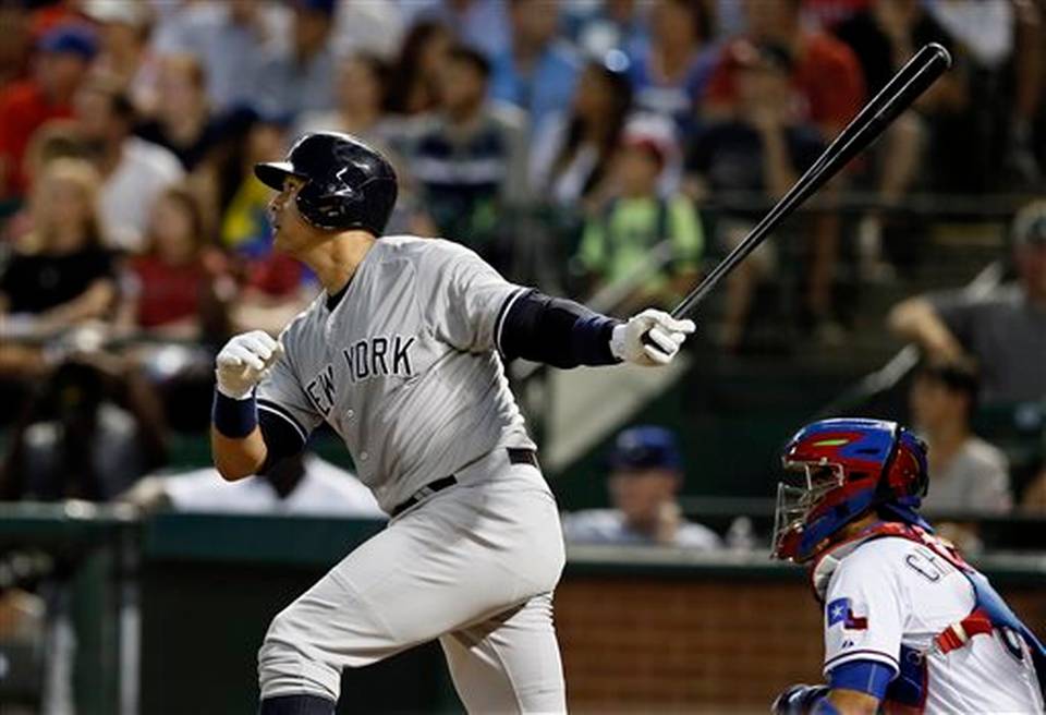 New York Yankees&#39 Alex Rodriguez follows through on a solo home run swing off a pitch from Texas Rangers&#39 Matt Harrison as Rangers catcher Robinson Chirinos watches in the sixth inning of a baseball game Monday