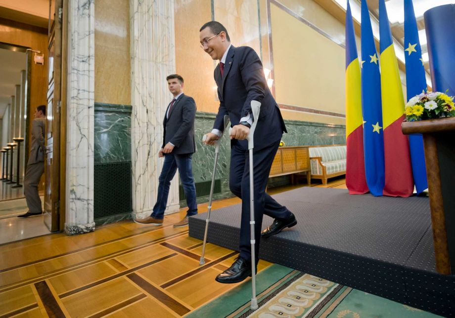 10 2015 Romanian Premier Victor Ponta walks with the aid of crutches in Bucharest Romania. Ponta announced Sunday