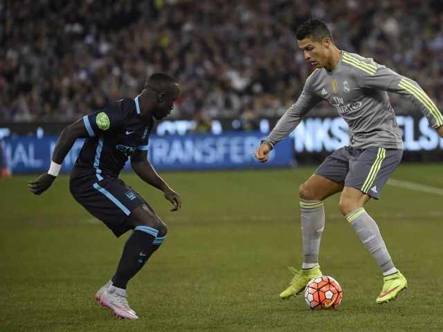 Bacary Sagna of Manchester City watches the footwork of Cristiano Ronaldo of Real Madrid during the International Champions Cup football match between English Premier League team Manchester City and Spanish side Real Madrid in Melbourne