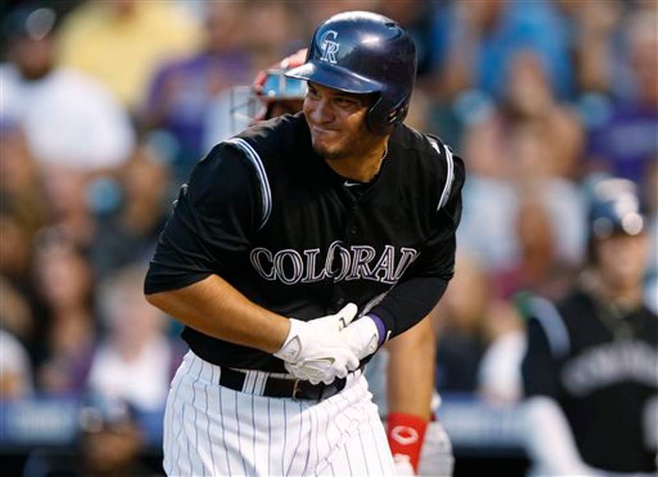 Colorado Rockies&#39 Nolan Arenado front reacts after getting hit in the hand by Cincinnati Reds starting pitcher Johnny Cueto in the seventh inning of a baseball game Saturday