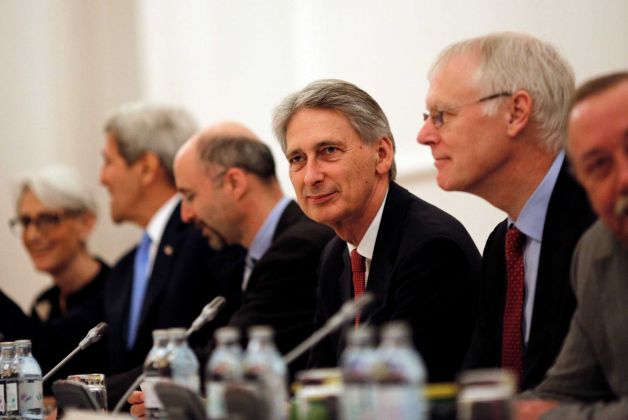 British Foreign Secretary Philip Hammond centre attends a meeting with foreign ministers and representatives of United States France Germany China Russia and the European Union during the current round of nuclear talks with Iran being held in Vienn