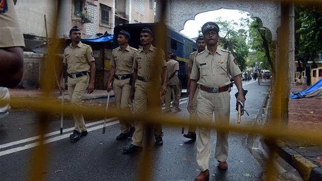 Indian policemen patrol a road leading to the residence of Yakub Memon a key plotter of the 1993 Bombay bombings which killed hundreds of people in 1993