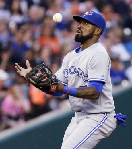 Toronto Blue Jays shortstop Jose Reyes bobbles a grounder hit by Detroit Tigers Ian Kinsler before throwing him out at first base during the sixth inning of a baseball game Friday