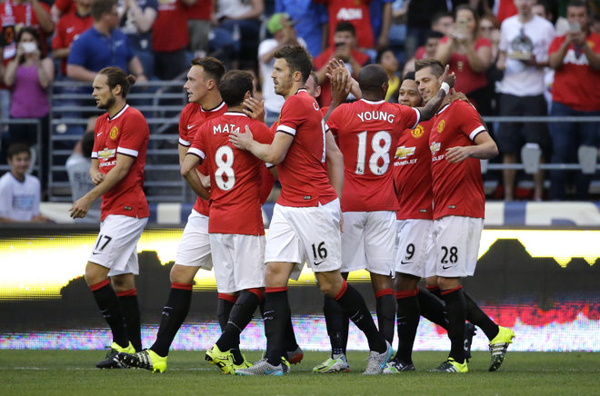 Manchester United's Morgan Schneiderlin, right celebrates with teammates after he scored a goal against Club America during the first half of an international friendly soccer match Friday