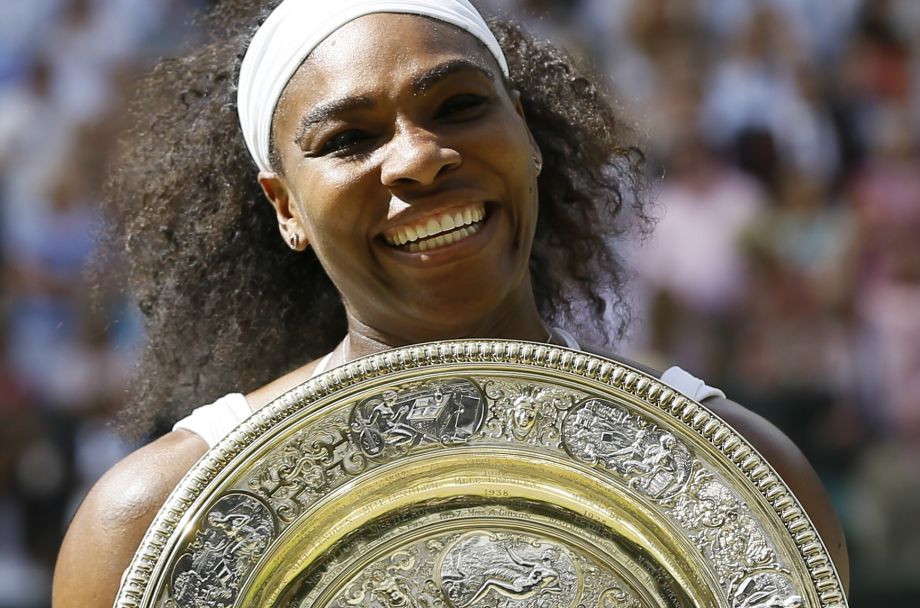 Serena Williams of the United States holds the trophy after winning the women's singles final against Garbine Muguruza of Spain at the All England Lawn Tennis Championships in Wimbledon London Saturday