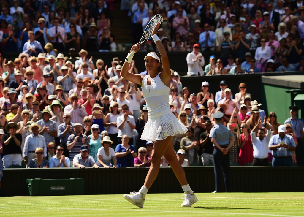 Garbine Muguruza of Spain celebrates after winning the Ladies Singles Semi Final match against Agnieszka Radwanska of Poland during day ten of the Wimbledon Lawn Tennis Championships at the All England Lawn Tennis and Croquet Club