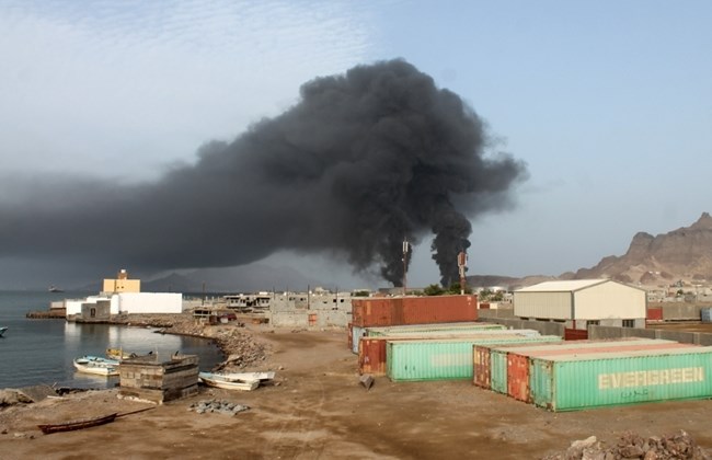 Smoke billows from an oil refinery in the port city of Aden