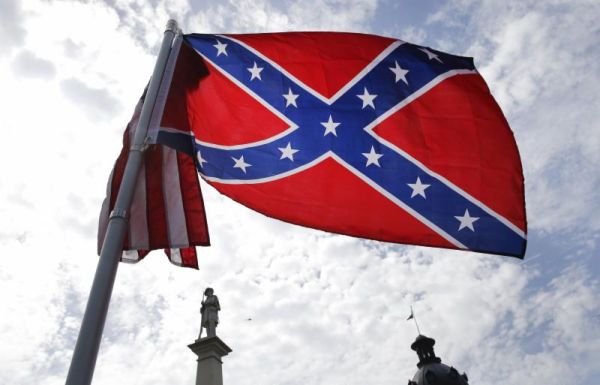 A protester waves a Confederate battle flag