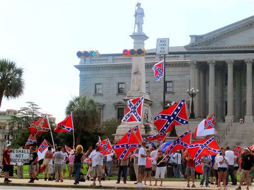 Supporters of keeping the Confederate battle flag flying at a Confederate monument at the South Carolina Statehouse wave flags during a rally in front of the statehouse in Columbia S.C. on Saturday