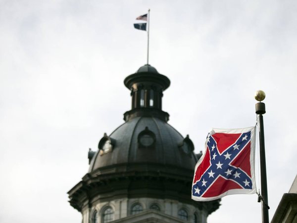 A Confederate battle flag flies in front of the South Carolina statehouse Wednesday