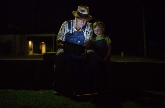 Decatur Ala. sits and waits with his granddaughter Mariah Lyerly 3 of Nashville Tenn. before the midnight book release of'Go Set a Watchman by author Harper Lee Tuesday