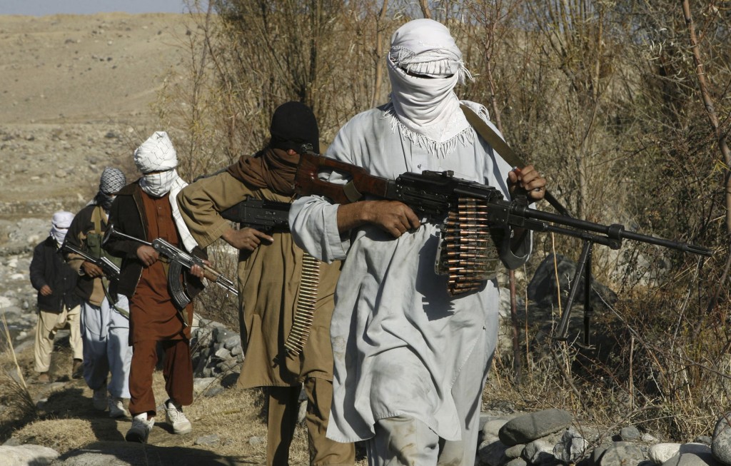 Taliban fighters pose with weapons in an undisclosed location in Nangarhar province