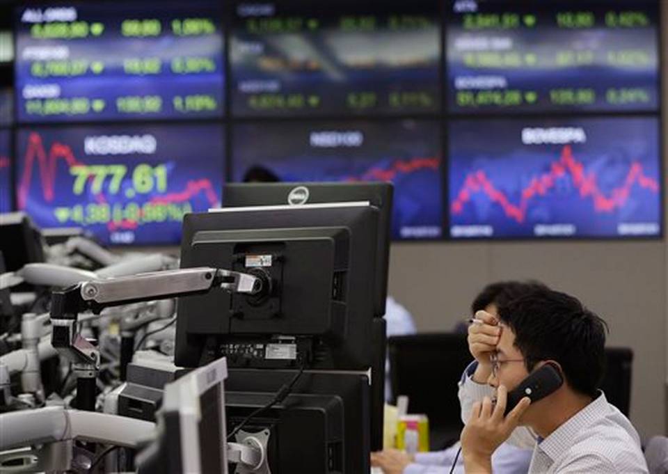 A currency trader speaks on the phone at the foreign exchange dealing room of the Korea Exchange Bank headquarters in Seoul South Korea Wednesday