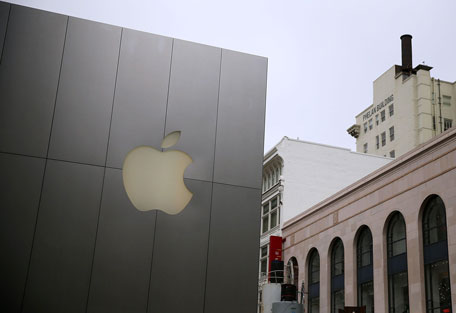 The Apple logo is displayed on the exterior of an Apple Store