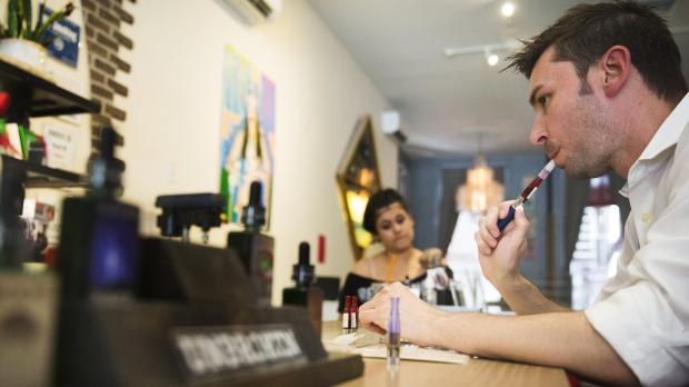 A customer tries different e-cigarette flavours at the Henley Vaporium in New York