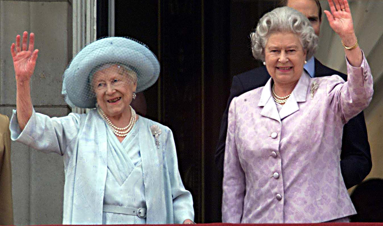 The Queen Mother waves to the people along side Queen Elizabeth II on the balcony of Buckingham Palace on her 100th birthday