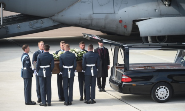 The coffin of one of the victims of last Friday's terrorist attack is taken from the RAF C-17 aircraft at RAF Brize