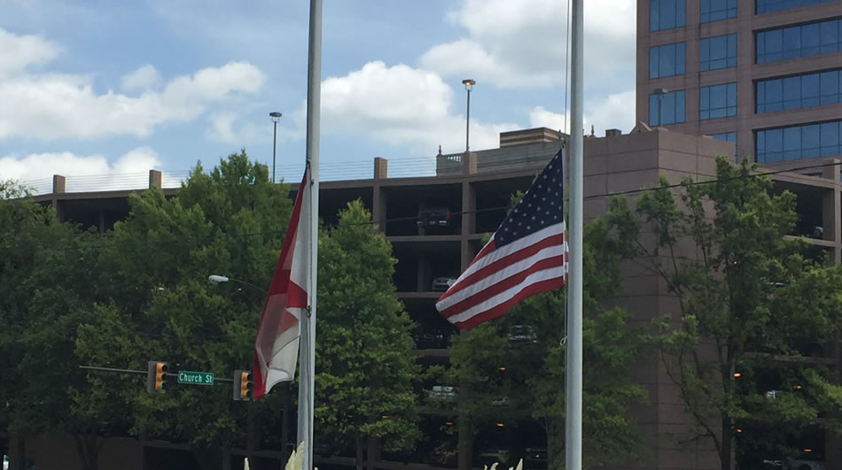 The flags outside WHNT News 19 at the corner of Church Street and Holmes Avenue are lowered to half staff