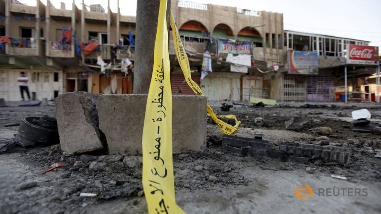 The site of a bomb attack is seen in Baghdad