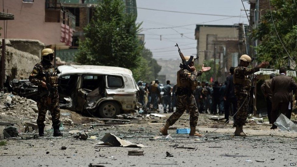 Afghan security personnel arrive at the site of a bomb blast that targeted Nato forces in Kabul