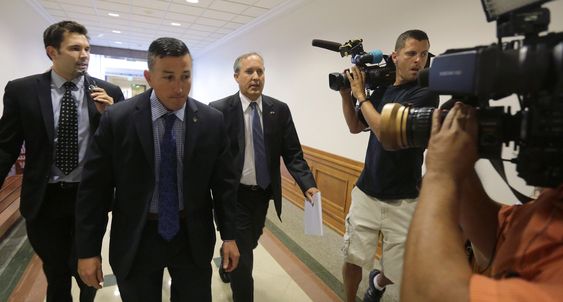 Ken Paxton third from left is followed by media after he testified at a Texas Senate Health and Human Services Committee hearing on Planned Parenthood videos covertly recorded that target the abortion provider Wednesday J