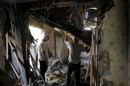 Local residents remove debris inside a damaged building which according to locals was caused by recent shelling in Avdiivka in Donetsk region Ukraine