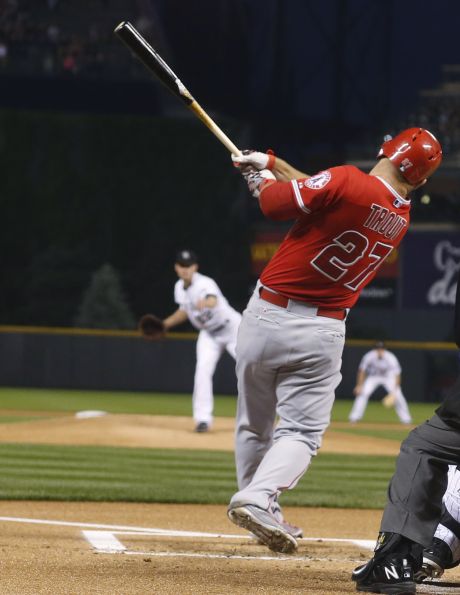 Los Angeles Angels Mike Trout follows through on a solo home run off Colorado Rockies starting pitcher Chris Rusin during the first inning of a baseball game Wednesday