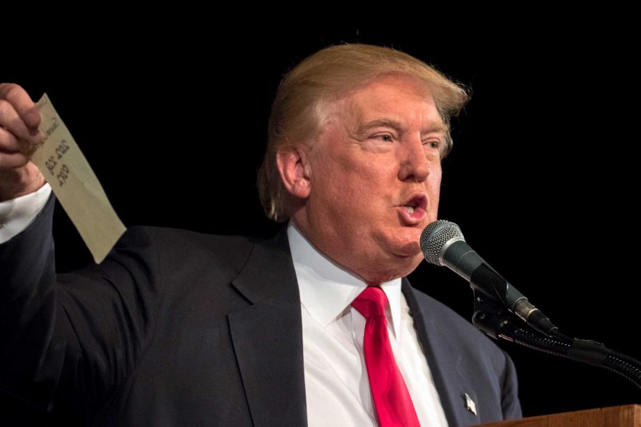 Republican presidential hopeful Donald Trump holds up a sheet of paper as he talks about calling Republican presidential candidate Sen. Lindsey Graham R-S.C. during his South Carolina campaign kickoff rally in Bluffton S.C. Tuesday