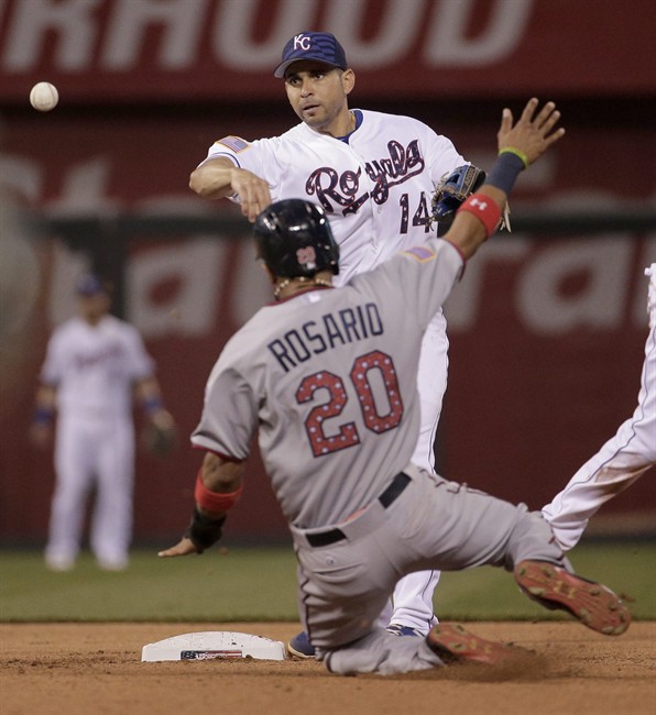 Kansas City Royals second baseman Omar Infante throws to first for the double play hit into by Minnesota Twins Miguel Sano after forcing out Eddie Rosario at second during the eighth inning of a baseball game Saturday