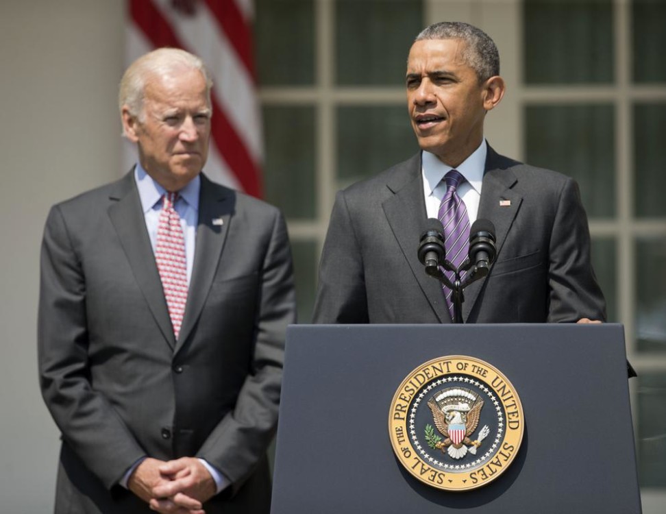 President Barack Obama accompanied by Vice President Joe Biden speaks in the Rose Garden of the White House in Washington on Wednesday. The president announced that the United States and Cuba have agreed to open embassies in each other's capitals