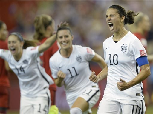 United States&#039 Carli Lloyd celebrates with teammates Ali Krieger and Morgan Brian after scoring on a penalty kick against Germany during the second half of a semifinal in the Women's World Cup soccer tournament Tuesday