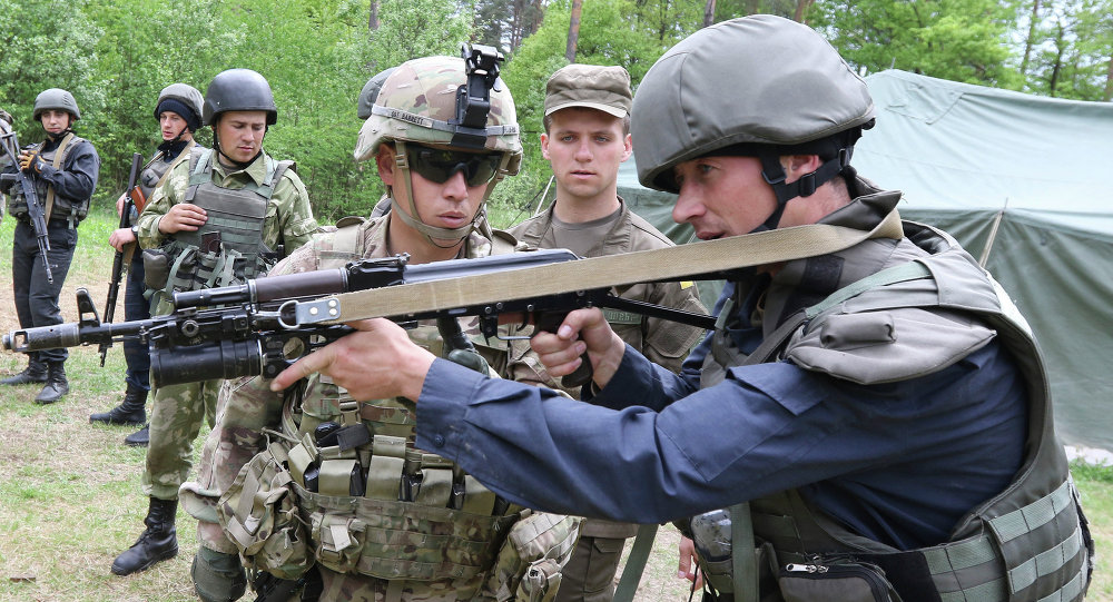 US Sgt Barrett left instructs a Ukrainian soldier during joint training exercises on the military base in the Lviv region western Ukraine Thursday