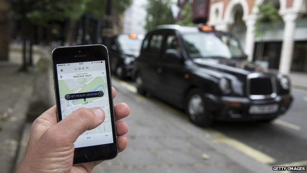 A smartphone displays the'Uber mobile application which allows users to hail private-hire cars from any location