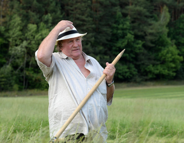 French actor Gerard Depardieu holds a hand scythe in the presidential residence of Ozerny outside Minsk Belarus