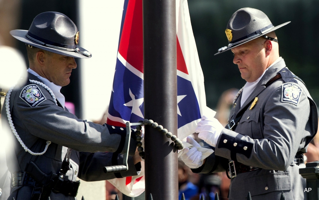 An honor guard from the South Carolina Highway patrol lowers the Confederate battle flag as it is removed from the Capitol grounds Friday