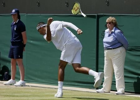 Nick Kyrgios of Australia throws his racket onto the ground and it bounces up into the fans during his match against Milos Raonic of Canada at the Wim