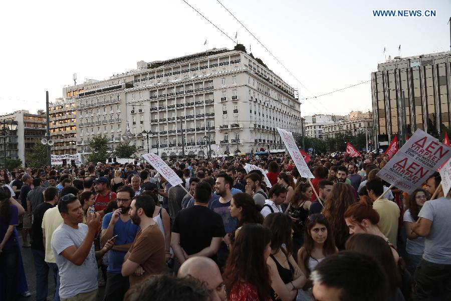 People participate in an anti-austerity rally in front of the Greek parliament in Athens Greece