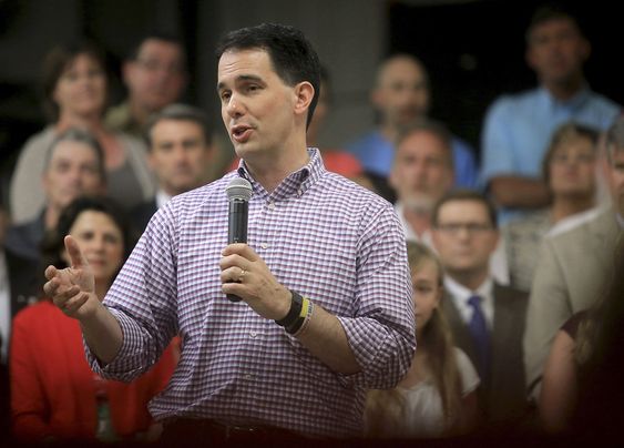 Wisconsin Gov. Scott Walker addresses employees and members of the media at Valveworks USA prior to signing the state's 2015-2017 budget on the production floor of the Waukesha Wis. company. Walker is fac