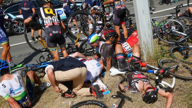 Riders and bikes lie strewn on the side of a Belgium road after a crash during the third stage of the Tour de France which forced a neutralisation of the stage