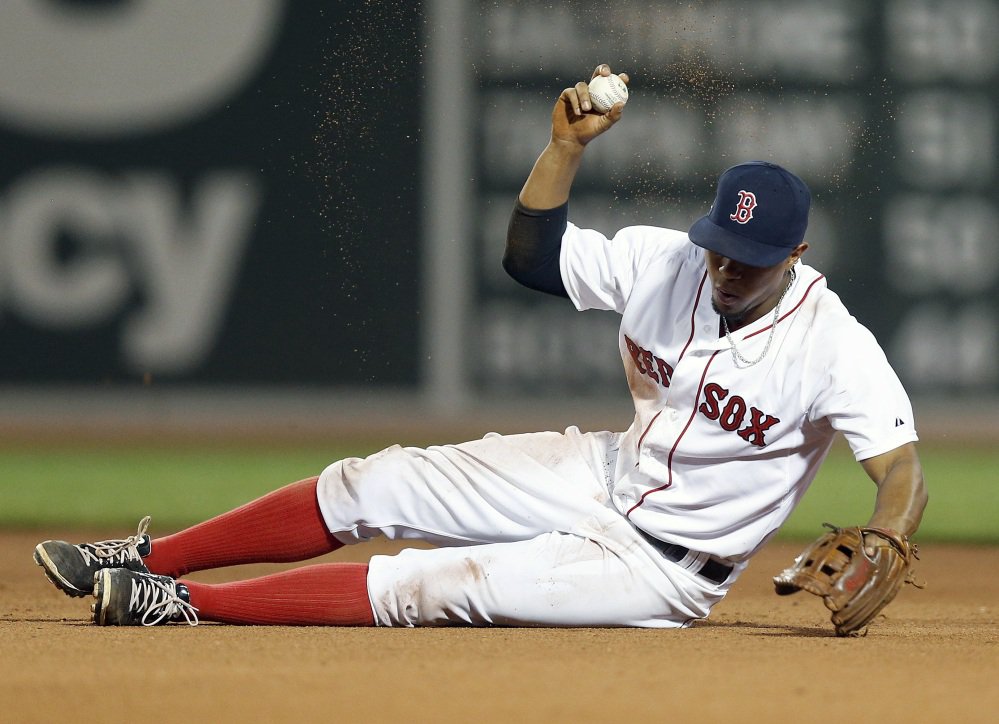 Boston’s Xander Bogaerts reacts after missing the out at second base against Chicago’s Jose Abreu on a throwing error by Alexi Ogando during the eighth inning of Wednesday night’s loss to the White Sox