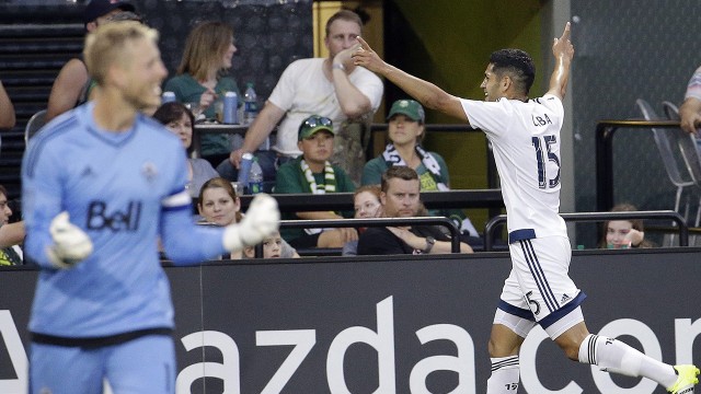 Whitecaps pass depth test in draw vs. Timbers					Vancouver Whitecaps midfielder Matias Laba celebrates his goal on Saturday