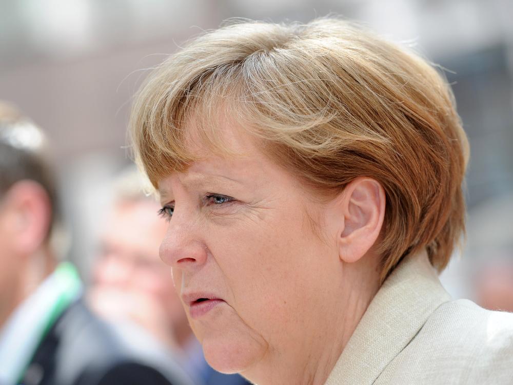 Germany's Chancellor Angela Merkel addresses reporters as she arrives at the European Council headquarters for an extraordinary summit of European leaders to deal with a worsening migration crisis