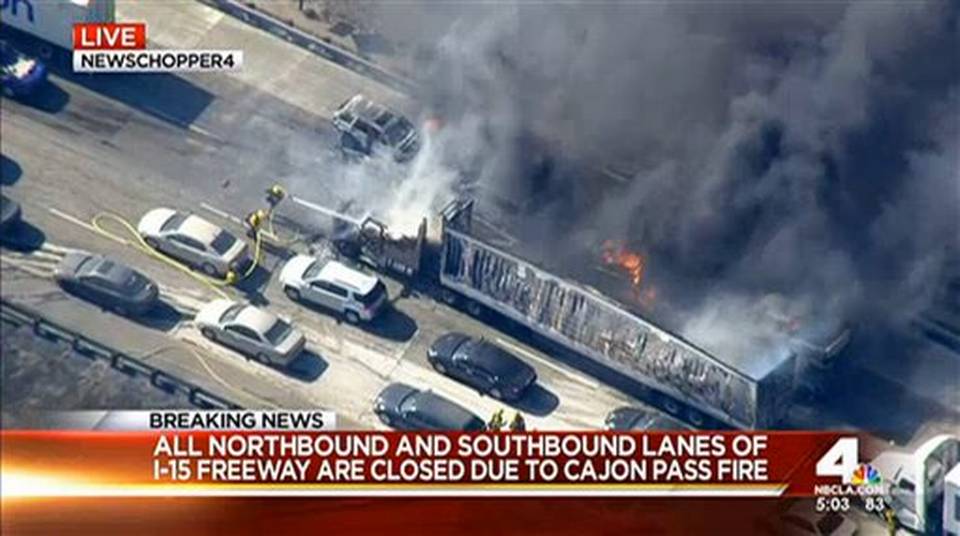 Wildfire sweeps across California freeway, burns cars