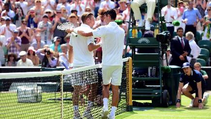 Novak Djokovic and Jarkko Nieminen talk at the net after their Centre Court clash